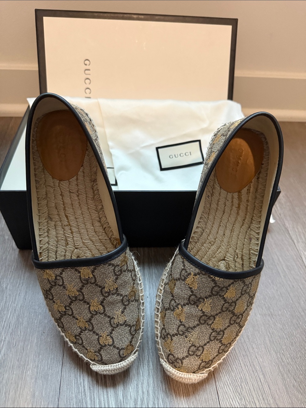 AUTHENTIC- Gucci slip-ons, with gold signature bee design.